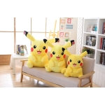 tres pikachus de diferentes tamaños sentados en un sofá beige en una bonita habitación