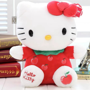 Simpático peluche de Hello Kitty con mariposa roja sentado frente a unos libros